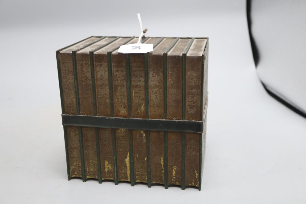 A biscuit tin in the form of eight leather bound Old Curiosity Shop books, (Huntley and Palmer), height 16cm